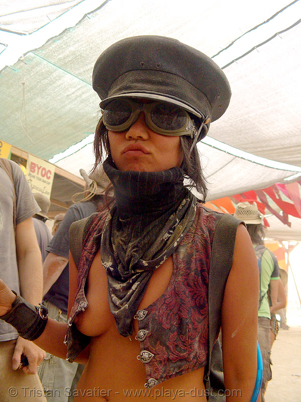 woman with goggles and army cap - nej "tank girl" - burning man 2007, breasts, burning man festival, center camp, dust storm, military cap, military hat, topless woman, stock photo