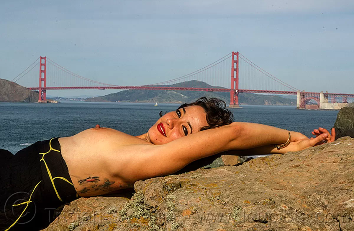 Topless Woman Sunbathing near Golden Gate Bridge