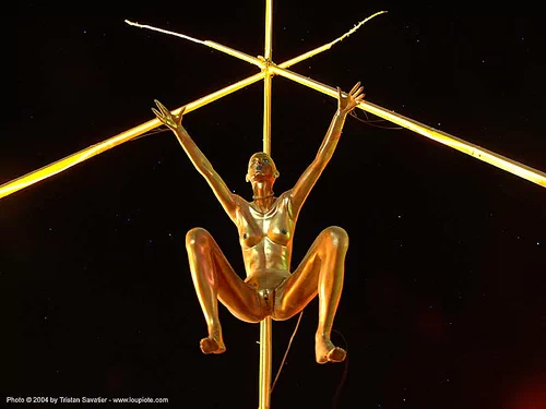 golden shower - art installation at burning man 2004, art installation, burning man at night, golden color, golden shower, scuplture, woman
