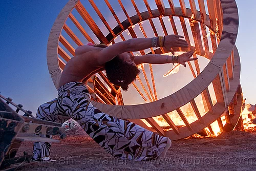 woman stretching near fire, burning, cylinder, cylindrical, dancing, dusk, fire, frame, heather, stretching, topless, woman, wood, wooden