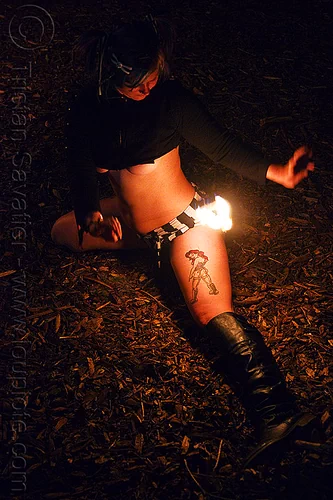 woman with tattoo - fire doohickey, fire dancer, fire dancing, fire doohickey, fire performer, fire spinning, fire wicks, haley, leg tattoo, night, tattooed, tattoos, woman